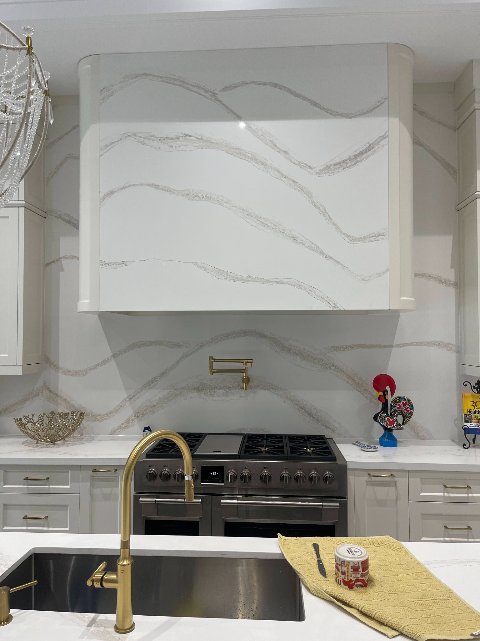 Luxury white quartz kitchen backsplash with soft flowing veining