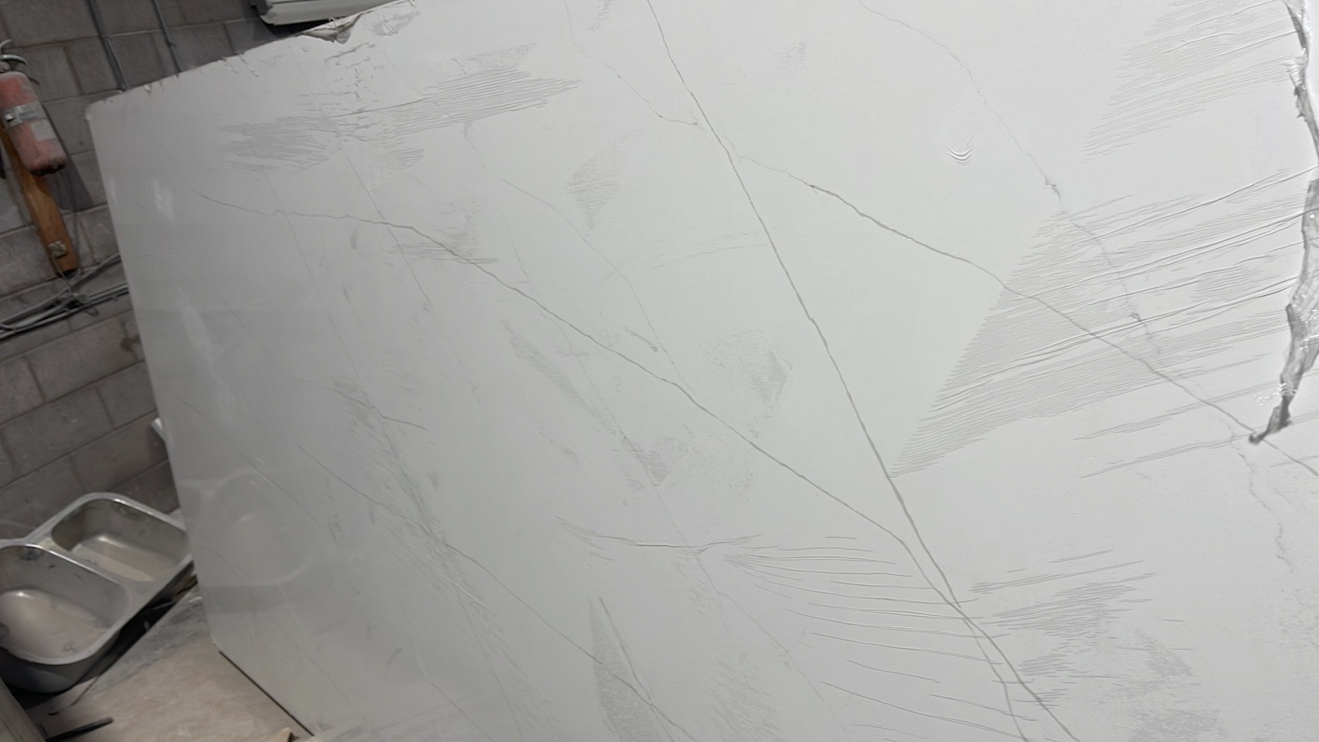 Large-format white quartz slab ready for countertop fabrication and installation